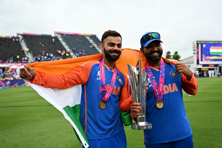Virat Kohli and Rohit Sharma celebrate with the trophy after winning the ICC men's Twenty20 World Cup 2024 final cricket match between India and South Africa at Kensington Oval in Bridgetown, Barbados, on June 29, 2024. (Photo by CHANDAN KHANNA / AFP)